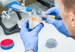 a dental laboratory technician making dentures