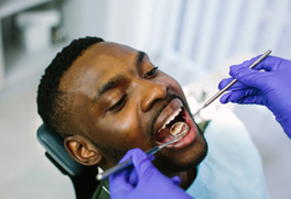 a man having his teeth examined at the dental office