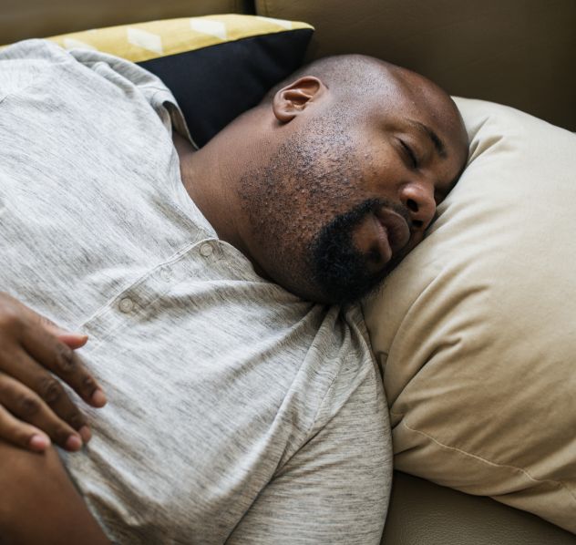 Man lying on pillow and snoring