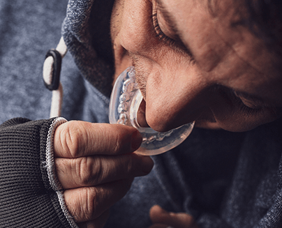 Man inserting a mouthguard to prevent dental emergencies in Midlothian