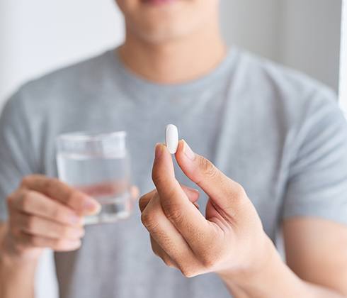 Patient holding an oral conscious dental sedation pill