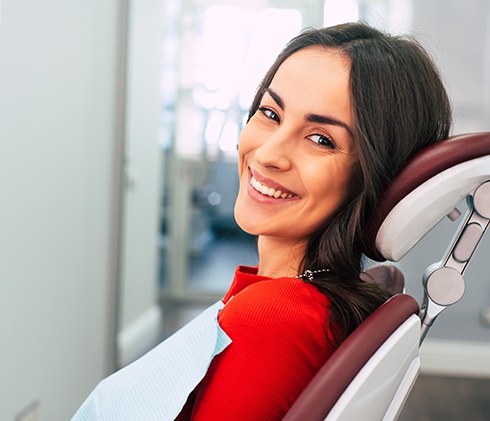 Woman smiling during appointment for dental services in Midlothian