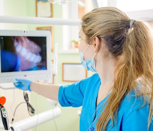 Dental team member looking at intraoral images