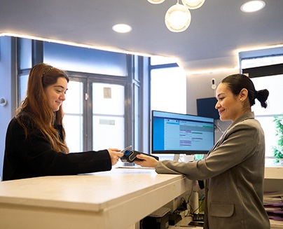 person in business casual suit collecting payment from a patient 