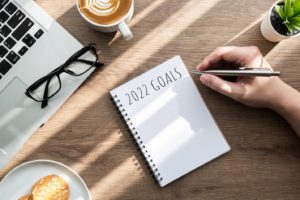 Patient writing down 2022 goals on notepad