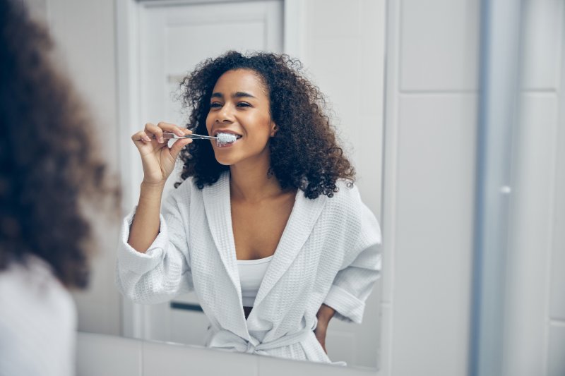 woman brushing her teeth