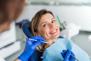 a smiling woman receiving a dental exam