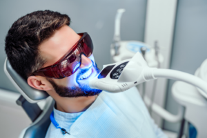 a man having his teeth whitened at a dental practice